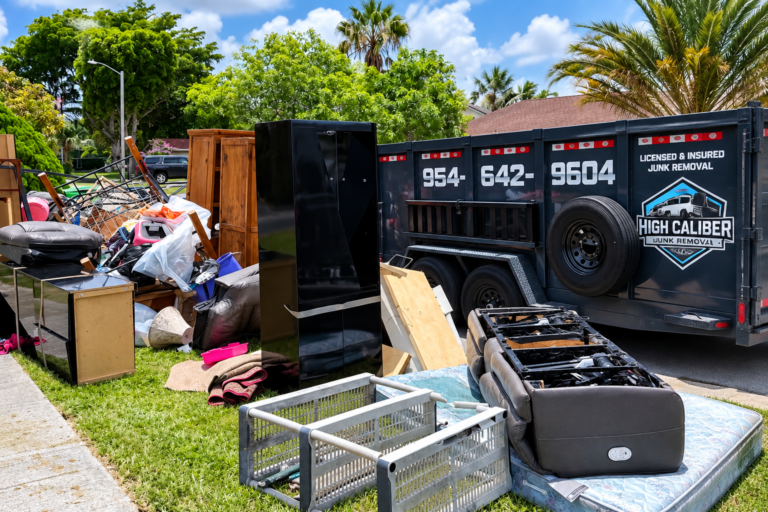 Property cleanout with furniture and High Caliber Junk Removal trailer