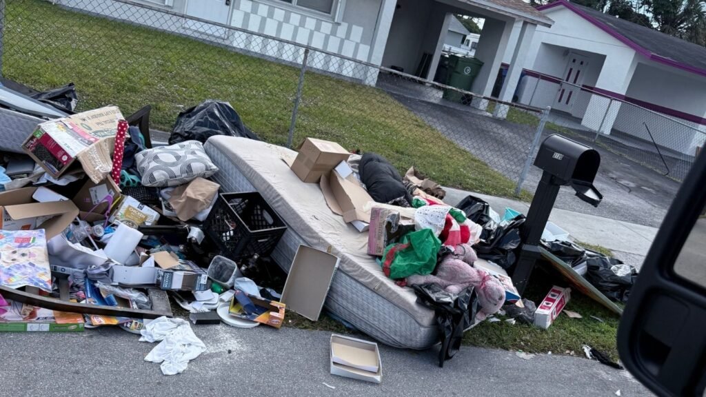 Curbside pile of furniture and household items from a property cleanout