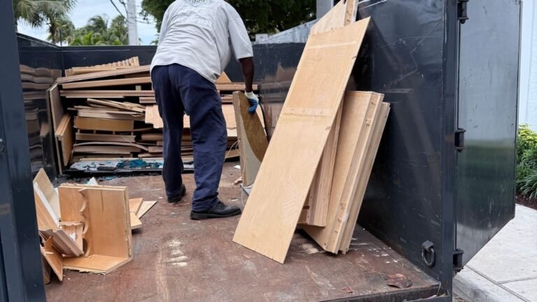 Construction debris being loaded into a junk removal trailer
